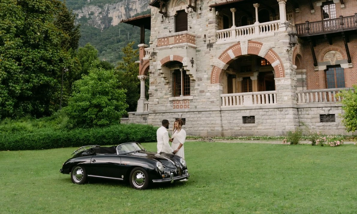 Couple with a vintage car in front of the villa